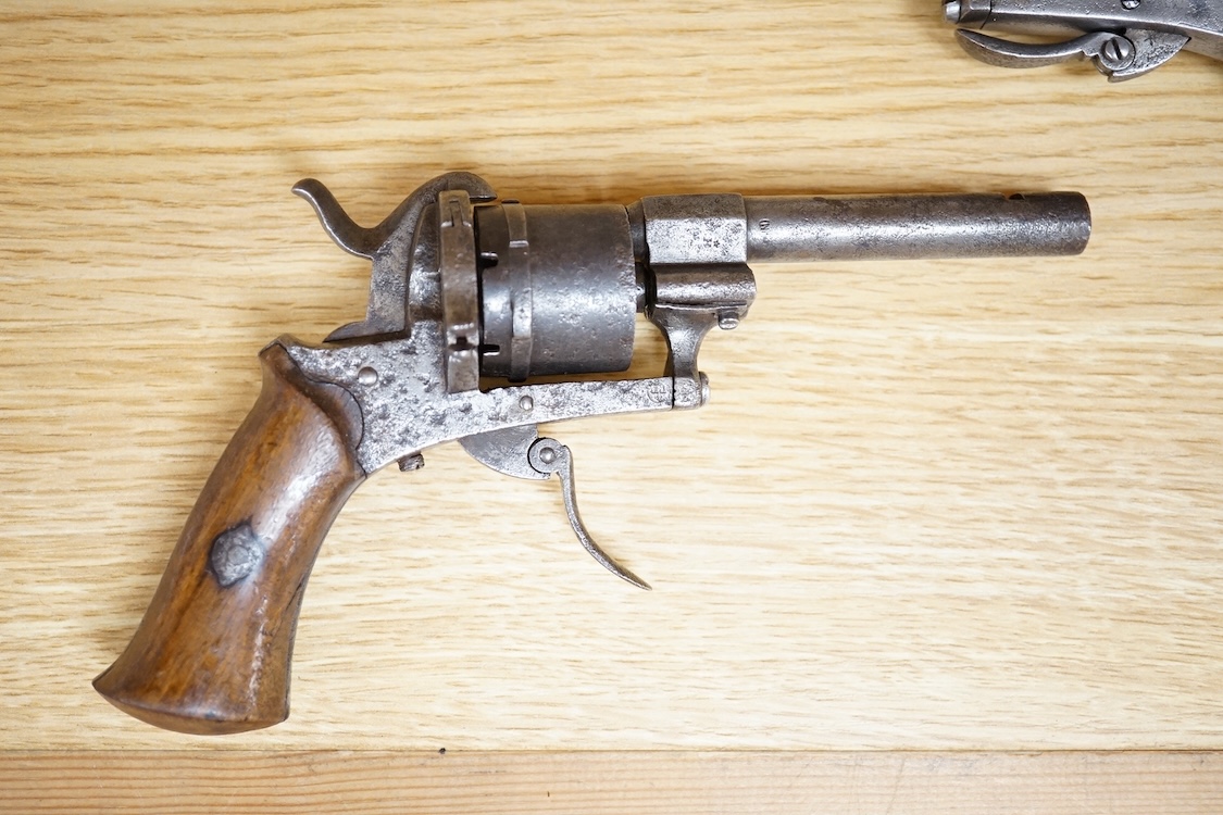 A six shot 7mm Belgian pinfire revolver and another similar, both with folding triggers and wooden grips